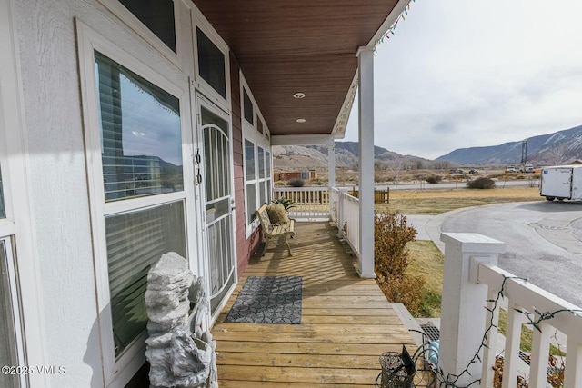 balcony with a mountain view and a porch