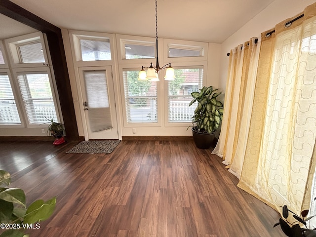 66 Bluegill Loop, Gypsum, CO 81637 - entryway featuring dark wood finished floors, a chandelier, baseboards, and lofted ceiling