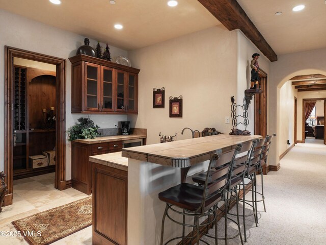 140 Elk Woods Rd, Edwards, CO 81632 - bar featuring arched walkways, recessed lighting, beamed ceiling, and light colored carpet