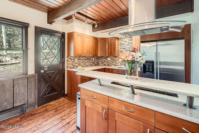 kitchen with stainless steel fridge, light wood-style floors, decorative backsplash, beamed ceiling, and wood ceiling