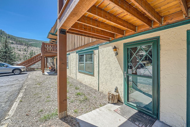 doorway to property featuring stucco siding