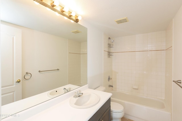 bathroom featuring visible vents, toilet, vanity, and shower / bathing tub combination