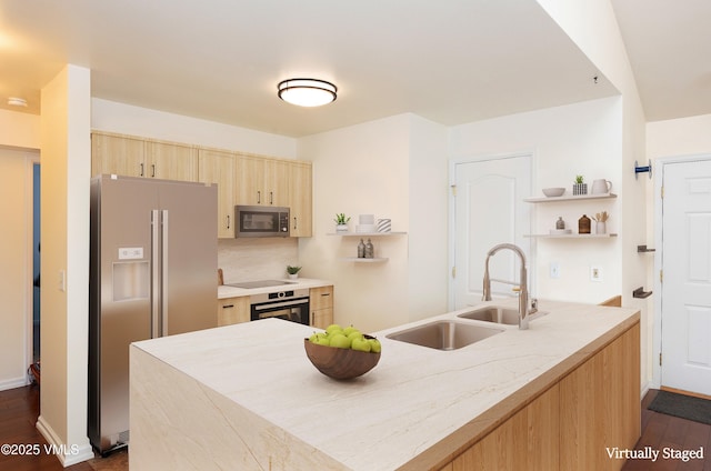 kitchen featuring light brown cabinetry, a sink, open shelves, stainless steel appliances, and light countertops