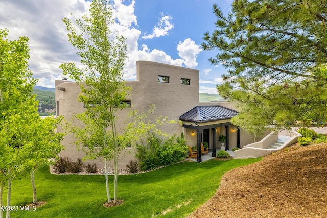 767 Charolais Cir, Edwards, CO 81632 - rear view of property with a standing seam roof, a metal roof, a yard, and stucco siding