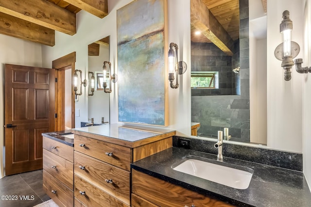 767 Charolais Cir, Edwards, CO 81632 - bathroom featuring vanity, beam ceiling, tiled shower, and tile patterned floors