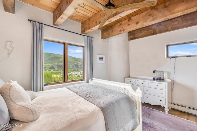 767 Charolais Cir, Edwards, CO 81632 - bedroom with a wooden ceiling with exposed beams, wood finished floors, and a baseboard radiator