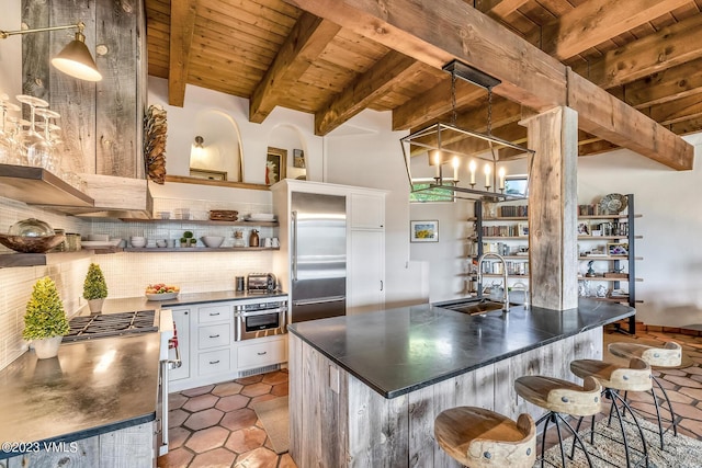 767 Charolais Cir, Edwards, CO 81632 - kitchen featuring a wood ceiling with exposed beams, dark countertops, stainless steel appliances, tasteful backsplash, and open shelves