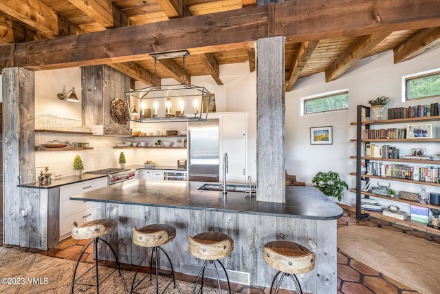 767 Charolais Cir, Edwards, CO 81632 - kitchen featuring open shelves, dark countertops, a wooden ceiling with exposed beams, built in fridge, and decorative backsplash