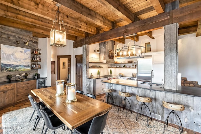 767 Charolais Cir, Edwards, CO 81632 - dining space with a chandelier, a wooden ceiling with exposed beams, wet bar, and wine cooler