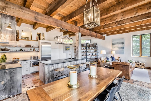 767 Charolais Cir, Edwards, CO 81632 - dining room featuring a wood ceiling with exposed beams, a chandelier, and light tile patterned floors