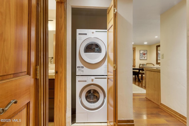 2821 Basingdale Blvd Unit 4, Vail, CO 81657 - laundry area featuring stacked washer and clothes dryer, wood finished floors, and recessed lighting