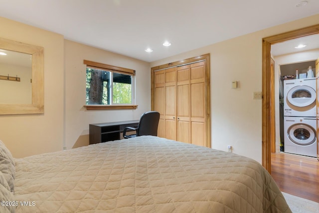 2821 Basingdale Blvd Unit 4, Vail, CO 81657 - bedroom featuring stacked washing machine and dryer, wood finished floors, recessed lighting, and a closet