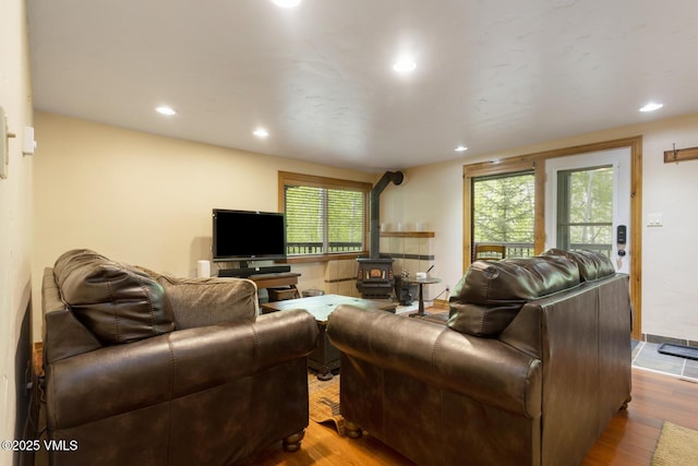 2821 Basingdale Blvd Unit 4, Vail, CO 81657 - living room with a wood stove, wood finished floors, plenty of natural light, and recessed lighting