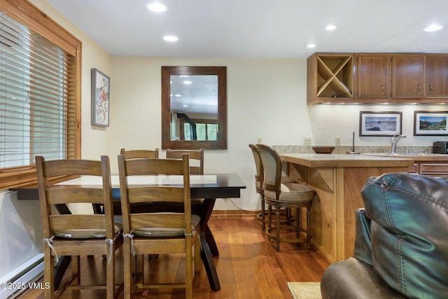 2821 Basingdale Blvd Unit 4, Vail, CO 81657 - dining space with bar with sink, wood finished floors, and recessed lighting