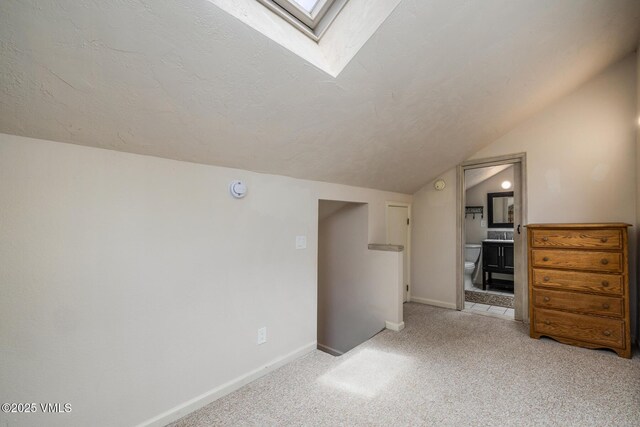 929 Red Sandstone Rd Unit 15D, Vail, CO 81657 - additional living space with carpet flooring, vaulted ceiling, a skylight, and a textured ceiling