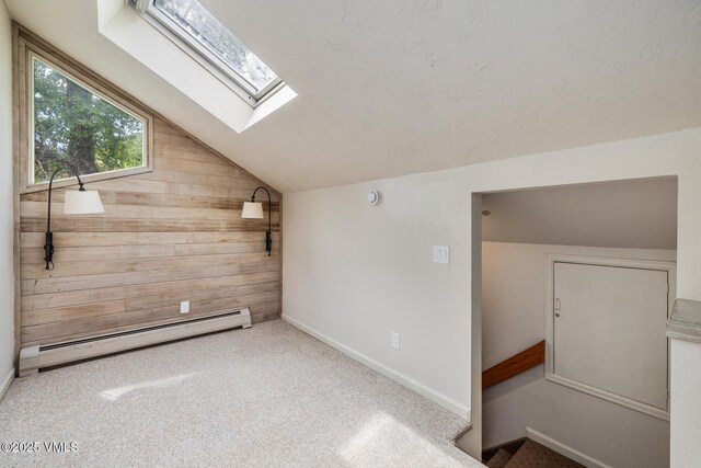 929 Red Sandstone Rd Unit 15D, Vail, CO 81657 - bonus room featuring baseboard heating, a skylight, lofted ceiling, wooden walls, and carpet flooring