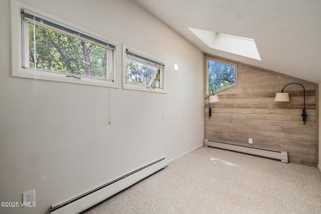 929 Red Sandstone Rd Unit 15D, Vail, CO 81657 - carpeted spare room with baseboard heating, a baseboard heating unit, a skylight, wooden walls, and lofted ceiling