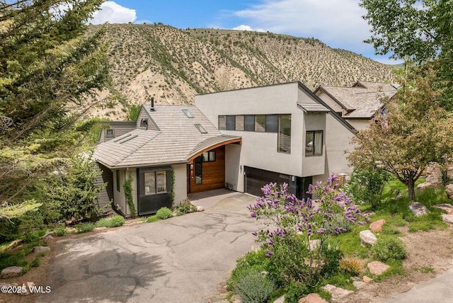 960 June Creek Rd, Edwards, CO 81632 - view of front of house featuring stucco siding, asphalt driveway, an attached garage, and a mountain view