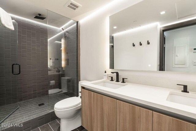174 Gore Creek Dr Unit 268, Vail, CO 81657 - full bathroom with double vanity, a shower stall, tile patterned flooring, and toilet