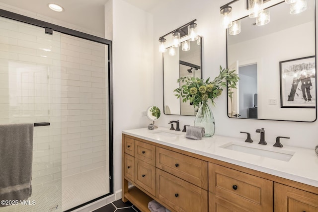 full bathroom with double vanity, a stall shower, and a sink