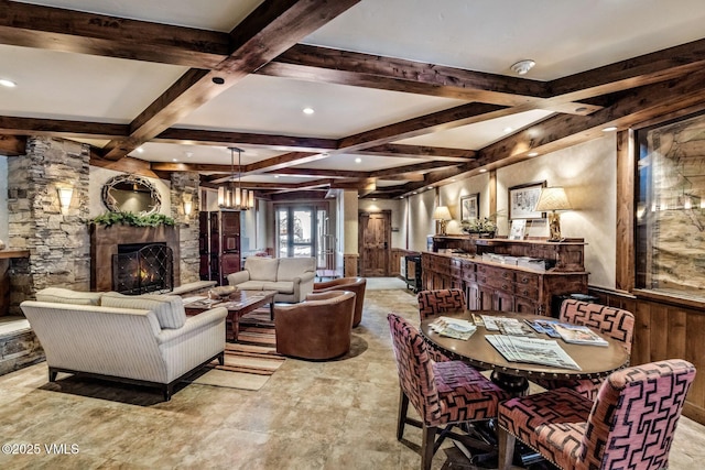 interior space featuring recessed lighting, beam ceiling, coffered ceiling, and a stone fireplace