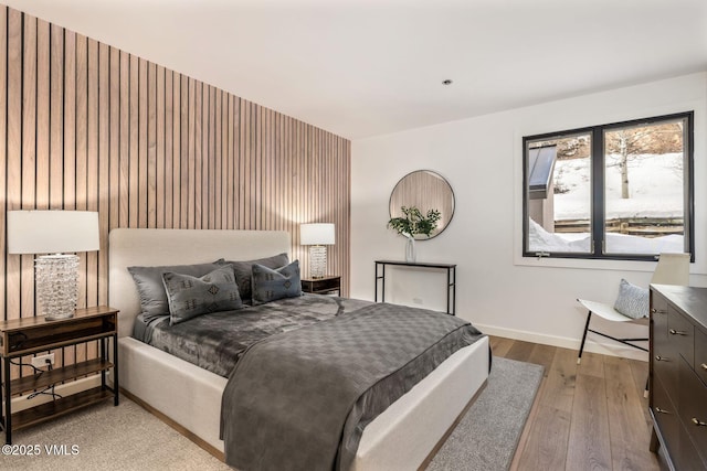 bedroom featuring hardwood / wood-style flooring and baseboards