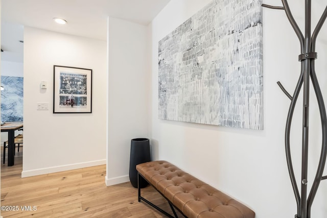 living area featuring light wood-style flooring, baseboards, and recessed lighting