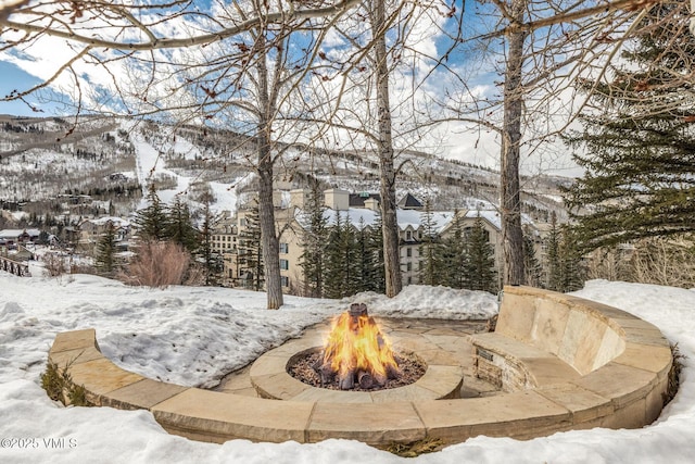 view of home's community with an outdoor fire pit