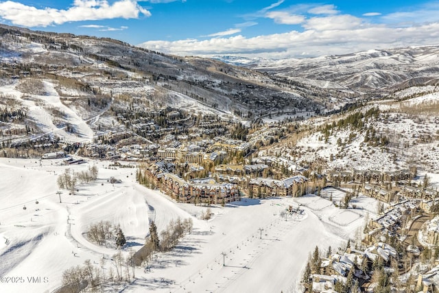 snowy aerial view featuring a mountain view