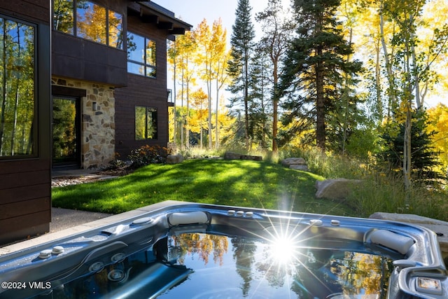 view of pool with a yard