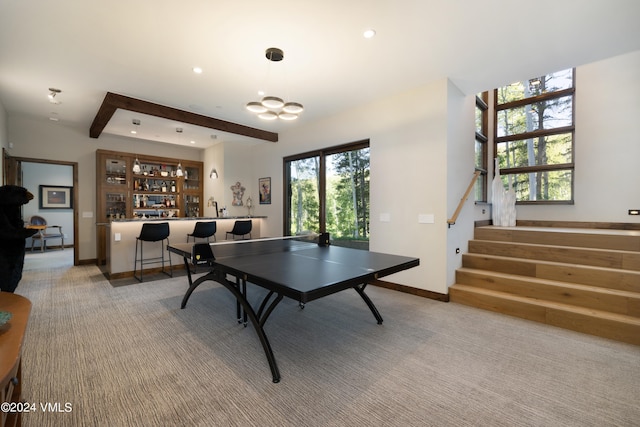 recreation room featuring a chandelier, recessed lighting, baseboards, beam ceiling, and carpet