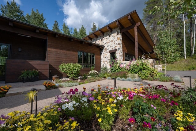 exterior space featuring stone siding