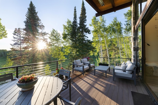 wooden terrace with an outdoor living space