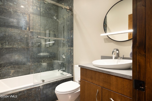 bathroom featuring shower / bath combination with glass door, vanity, and toilet