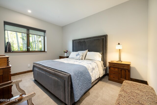 bedroom with recessed lighting, light carpet, and baseboards