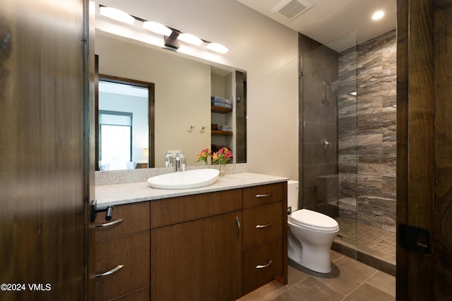 full bathroom with toilet, vanity, visible vents, a shower stall, and tile patterned floors