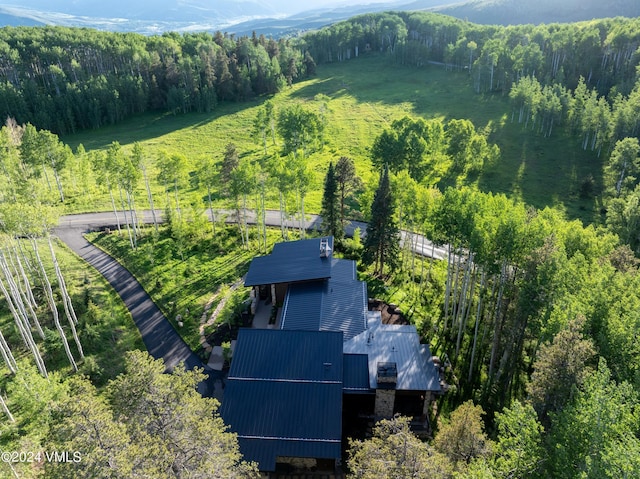 birds eye view of property with a view of trees