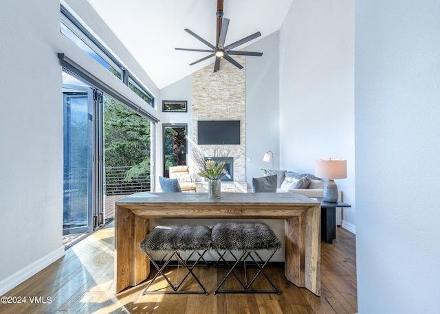 interior space featuring a stone fireplace and ceiling fan