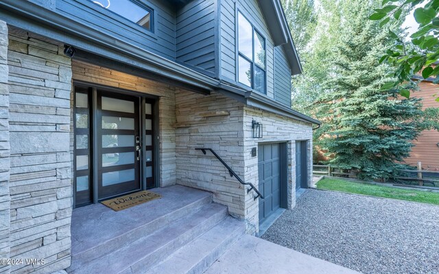 view of exterior entry with a garage