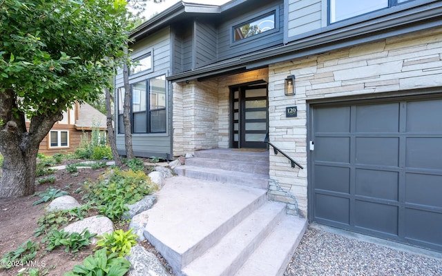 view of exterior entry with a garage