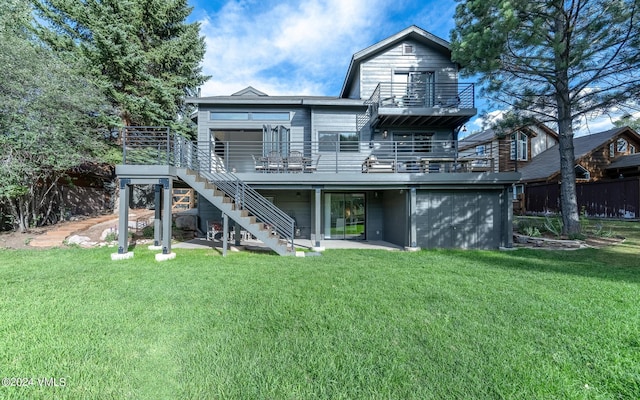 back of property with a wooden deck and a lawn