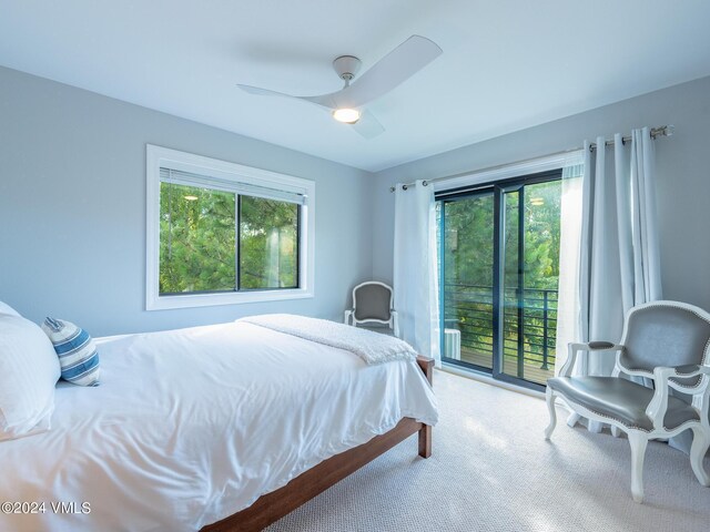 carpeted bedroom with ceiling fan and access to exterior