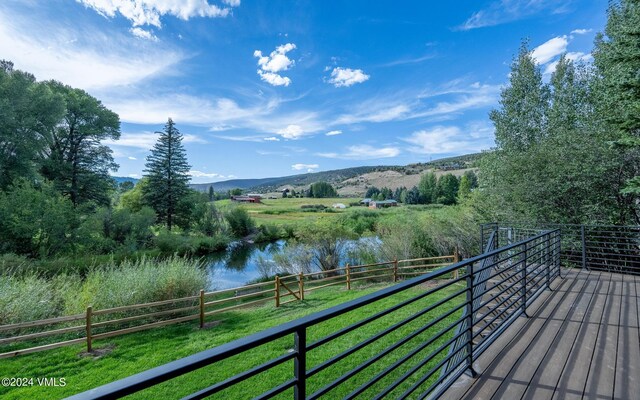 balcony with a rural view and a water and mountain view