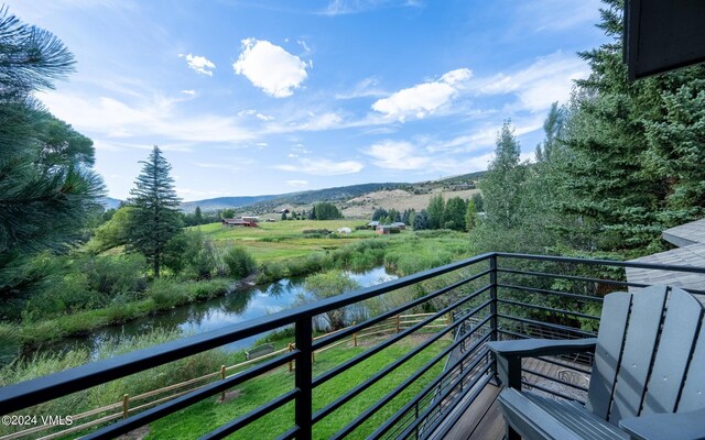 balcony with a water and mountain view