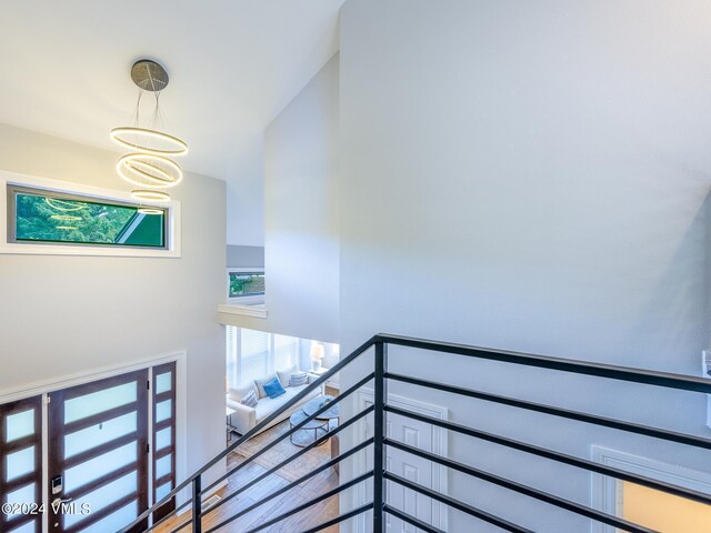 stairs with a chandelier