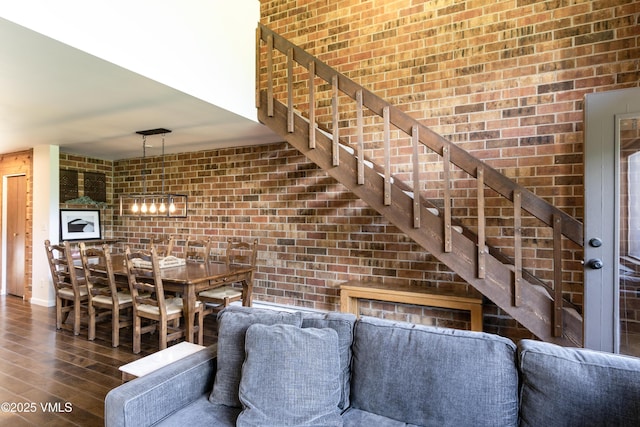 54 Columbine Cir Unit 14, Eagle-Vail, CO 81620 - unfurnished living room with wood finished floors, brick wall, and stairs