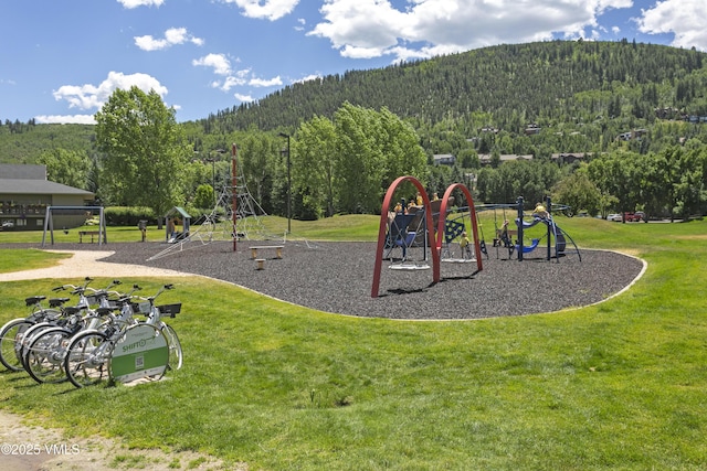 54 Columbine Cir Unit 14, Eagle-Vail, CO 81620 - community play area with a forest view, a yard, and a mountain view