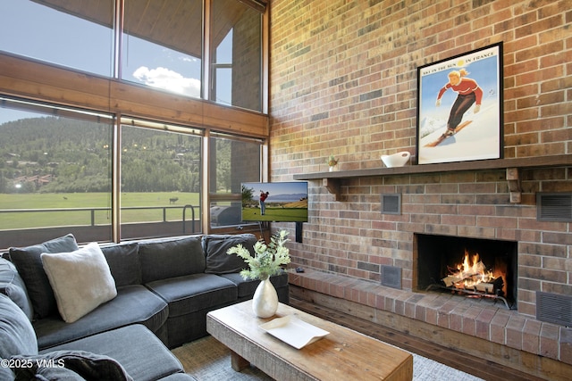 54 Columbine Cir Unit 14, Eagle-Vail, CO 81620 - living room with a fireplace, a high ceiling, and plenty of natural light