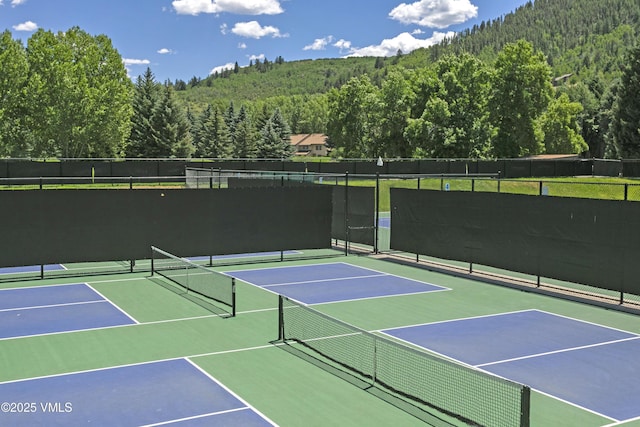 54 Columbine Cir Unit 14, Eagle-Vail, CO 81620 - view of tennis court featuring community basketball court and a forest view