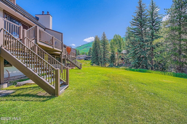 1750 S Frontage Rd W Unit E-3, Vail, CO 81657 - view of grassy yard with a deck with mountain view and stairs